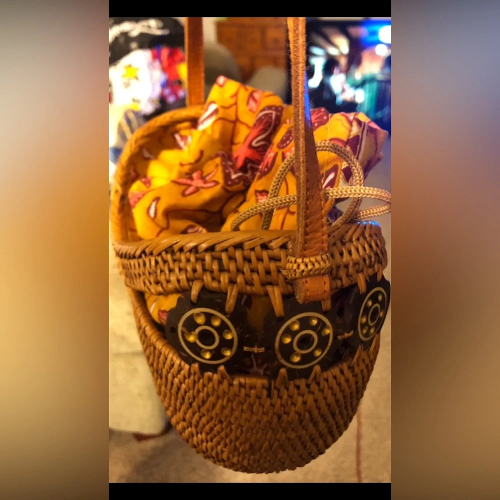 Balinese rattan crossbody bag featuring a vibrant yellow batik fabric lining